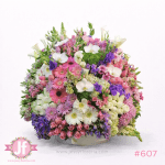 Caja circular vintage grande con rosas, gerberas, orquídeas y flores surtidas para envío de flores a domicilio en Guadalajara y zona metropolitana.